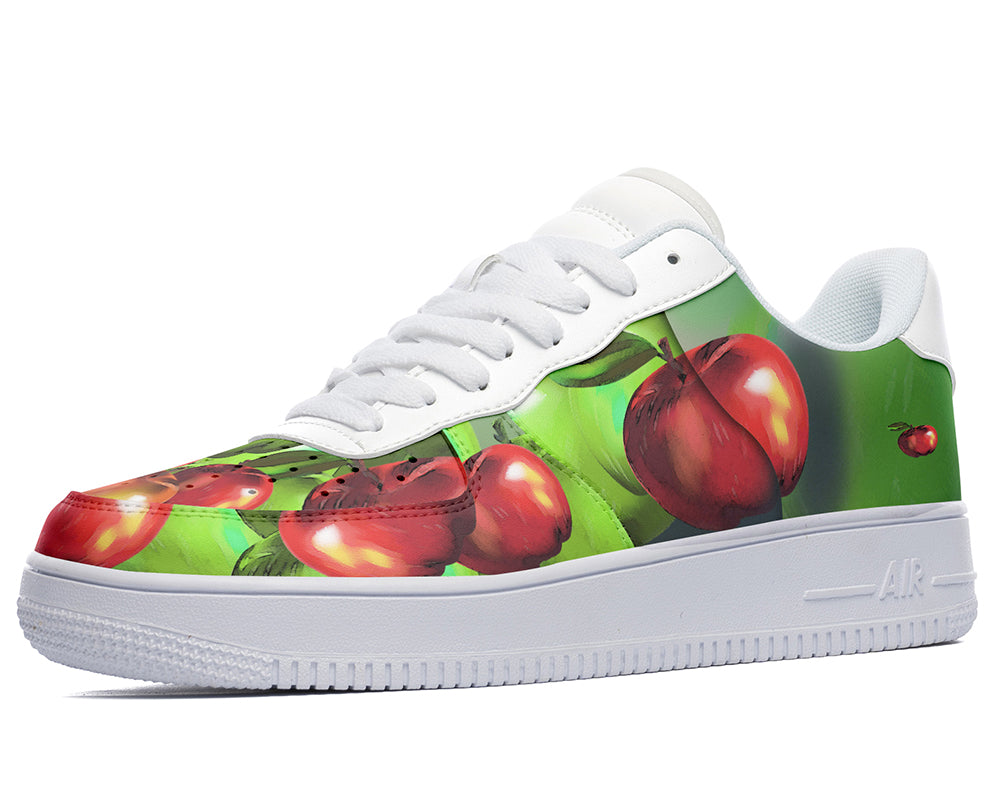 White sneakers with a green and apple print.