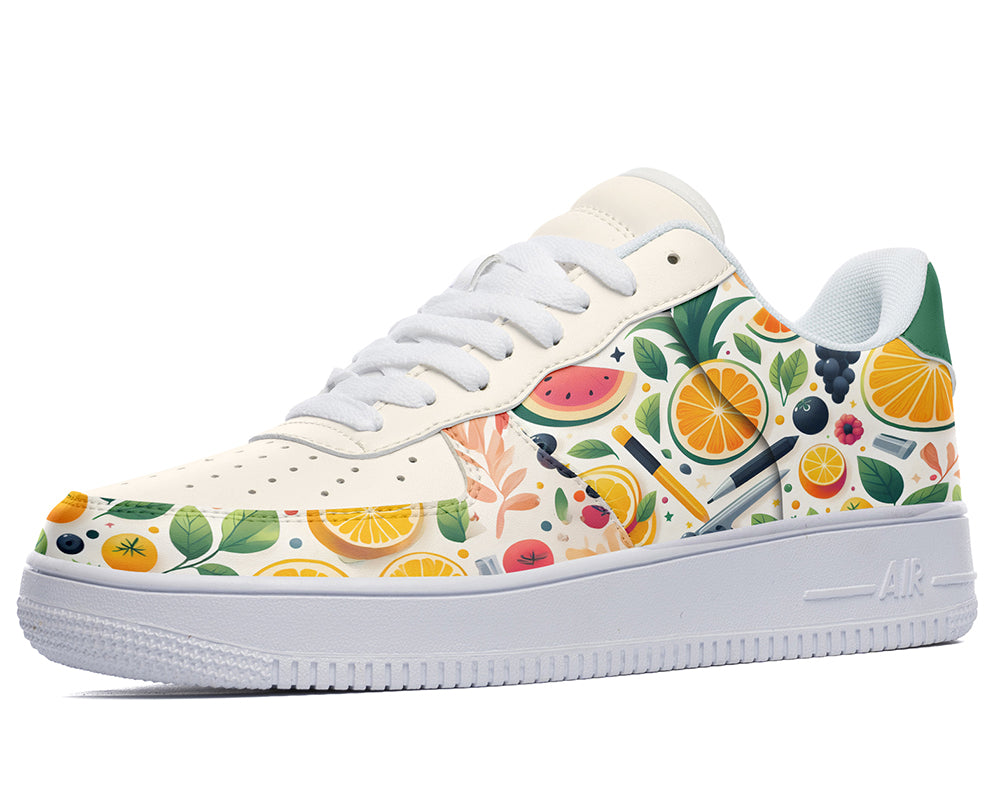 White sneakers with a fruit and stationery design. The design features oranges, watermelons, pineapples, leaves, pencils, pens, and a sharpener.