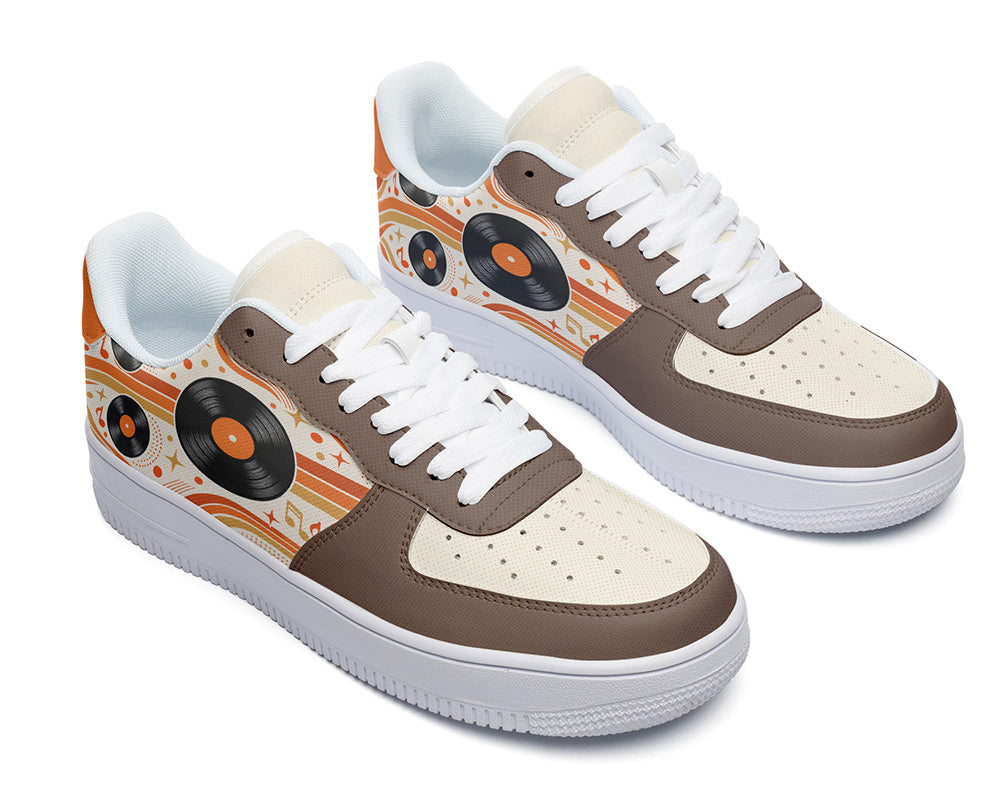 Court sneakers in white sole featuring black vinyl LP records over orange and cream retro wave lines with brown leather overlays.