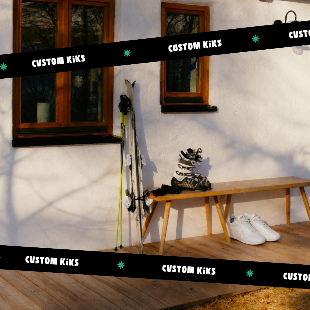white sneakers on the ground next to ski boots and ski poles, ribbons across the image with the Custom Kiks logo 