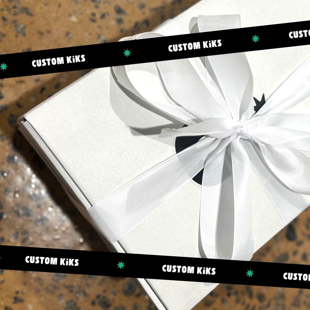 White Custom Kiks corporate employee gift box tied with a white ribbon