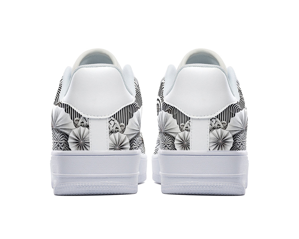 White court sneakers featuring black and white origami-inspired artwork with geometric paper-folding patterns and abstract monochrome design details.