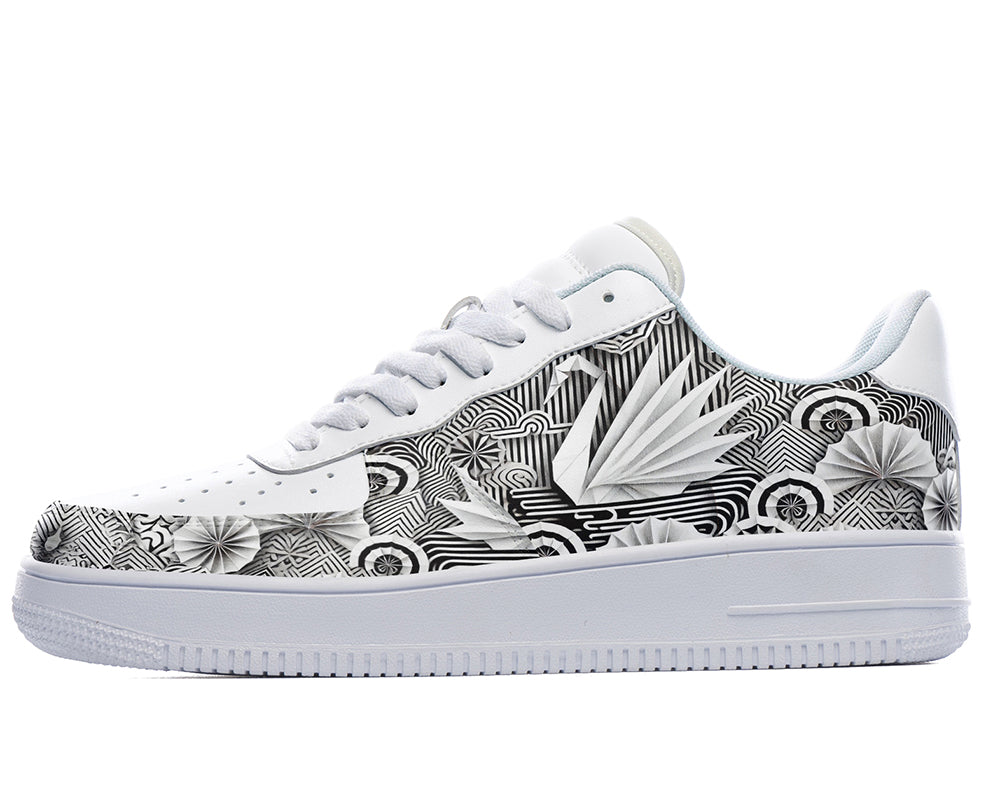 White court sneakers featuring black and white origami-inspired artwork with geometric paper-folding patterns and abstract monochrome design details.
