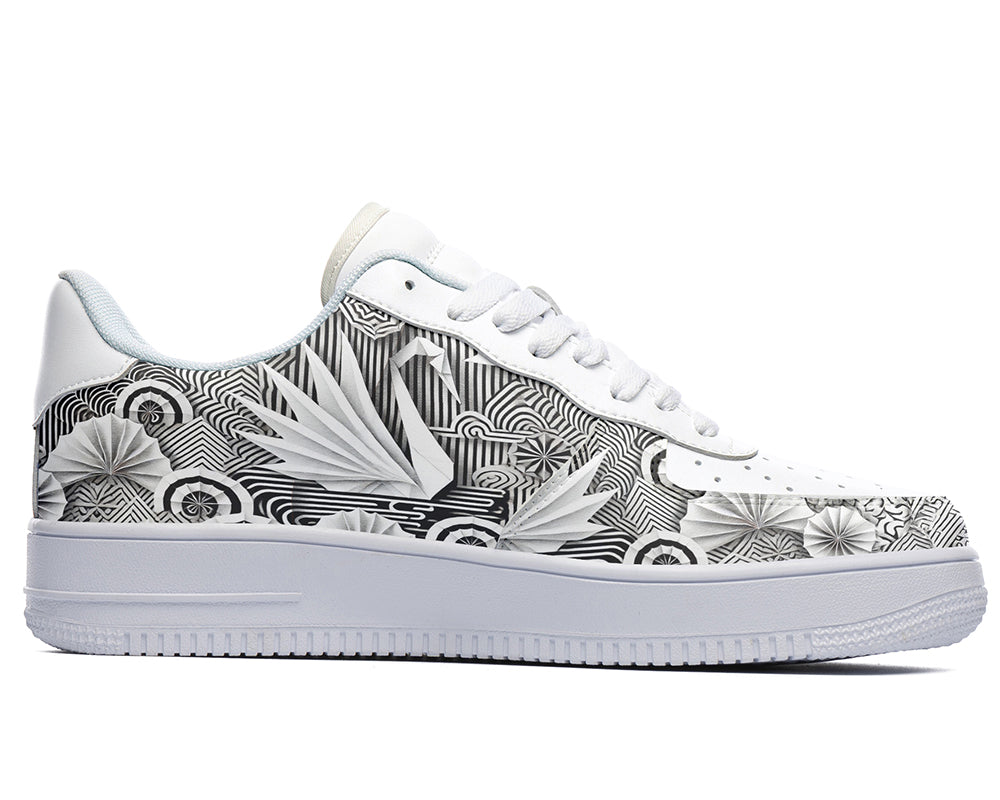 White court sneakers featuring black and white origami-inspired artwork with geometric paper-folding patterns and abstract monochrome design details.