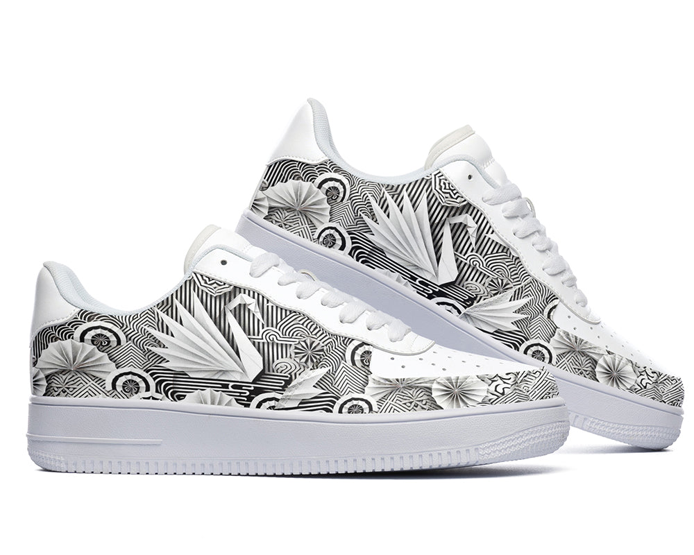 White court sneakers featuring black and white origami-inspired artwork with geometric paper-folding patterns and abstract monochrome design details.