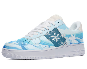 A close-up of a sneaker with a light blue and white color scheme. The sneaker has a white sole and white laces. The upper part of the sneaker is light blue with a snowflake pattern.