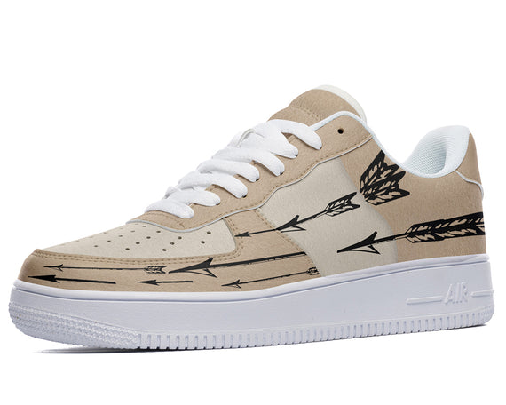 Beige sneakers with a black arrow design. 