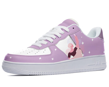 Purple sneakers with a white star pattern and a design of a woman in a pink tutu with her arms raised. 
