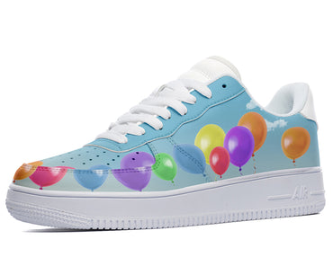 White sneakers with a blue and white design featuring a string of colorful balloons. 
