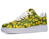 A white sneaker with a bright yellow pattern of bananas.