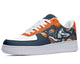 White, navy, and orange sneakers with a basketball-themed print.  The design features basketballs, sneakers, and basketball hoops. 
