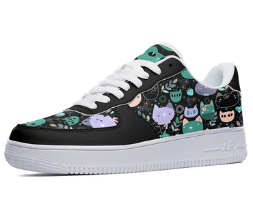 A black sneaker with a white sole and white laces. The sneaker has a design of colorful cats wearing party hats on it.