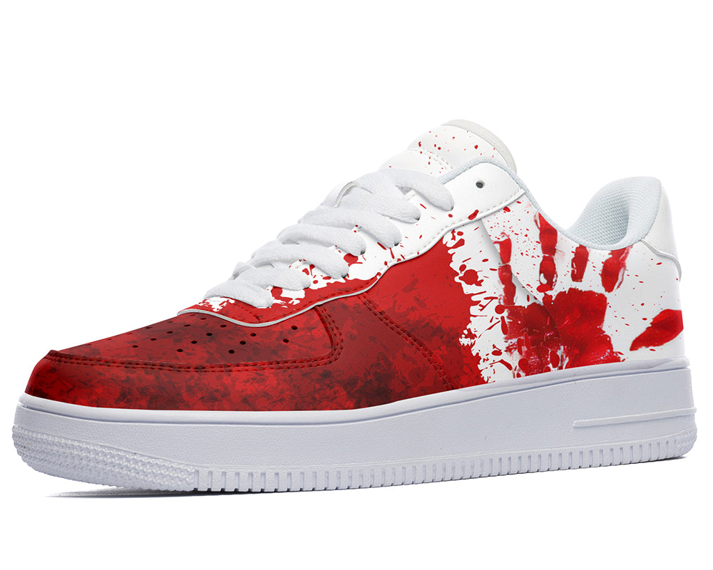 Red and white sneaker with a splatter design on a white background