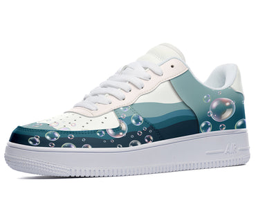 White sneakers with a blue, green, and white design of bubbles and wavy lines. 
