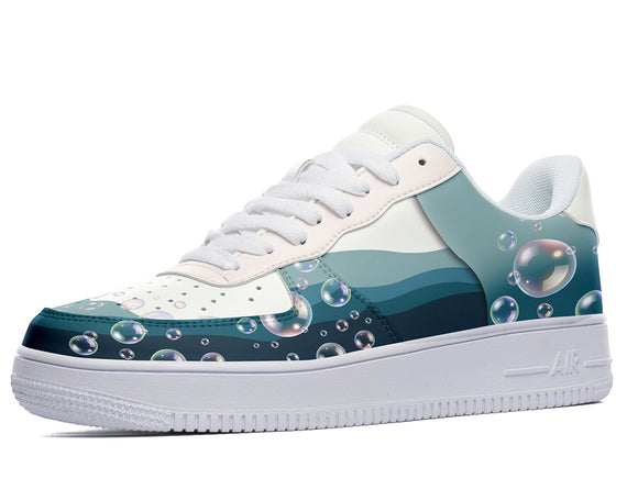 White sneakers with a blue, green, and white design of bubbles and wavy lines. 