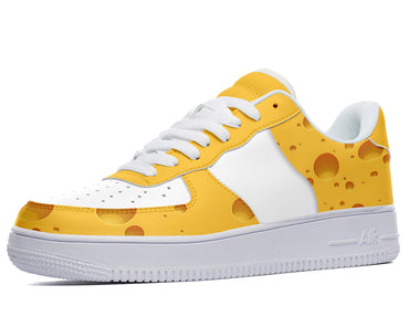 White and yellow low-top sneakers with a swiss cheese design. 