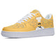 A yellow sneaker with a white sole and white laces. The sneaker has a design of a chef's hat and mustache on the side.