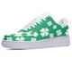 A white sneaker with a green pattern of four-leaf clovers.