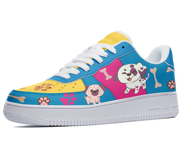 A colorful sneaker with a design of cartoon dogs, bones, and paw prints on a blue, yellow, and pink background.