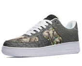 A close-up of a sneaker with a white sole and a textured gray upper. The sneaker has a black toe cap and a black Swoosh. The upper is decorated with a pattern of realistic African elephants.