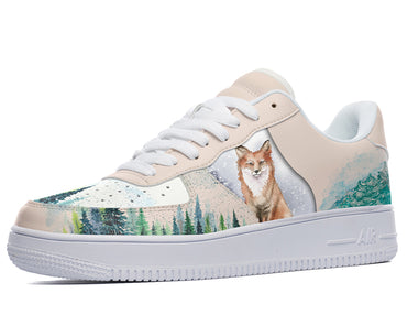 White sneakers with a watercolor design of a fox standing in a snowy forest.