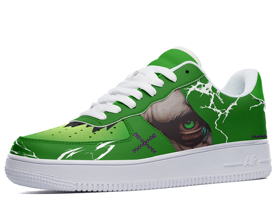 A green sneaker with a white sole and white laces. The green upper has a design of a face with purple eyes and a black mouth.