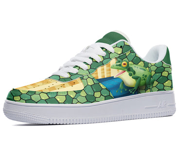 A green and white sneaker with a cartoon frog wearing a yellow shirt on the side. The frog is sitting on a blue and white checkered floor. The sneaker has a white sole and a green swoosh.