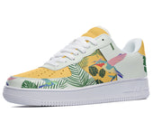 A white and yellow sneaker with a tropical pattern. The pattern features palm leaves, flowers, and hummingbirds.