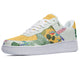 A white and yellow sneaker with a tropical pattern. The pattern features palm leaves, flowers, and hummingbirds.