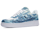 A close-up of a sneaker with a white sole and a blue and white upper. The upper is decorated with a design of crashing waves.