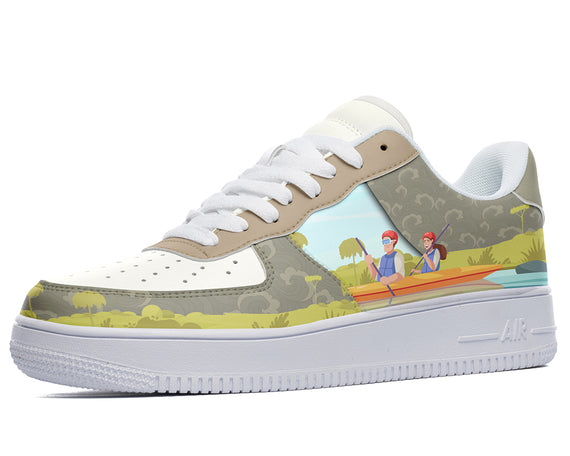 A white sneaker with a green and brown pattern. There is an illustration of two people in a canoe on the side of the shoe.