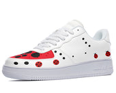 White sneakers with a red and black ladybug design. The design features ladybugs of various sizes scattered across the shoe.