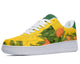 A yellow sneaker with a white sole and green heel. The sneaker has a tropical fruit design on the upper.