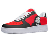 A low-top sneaker with a red upper and black toe and heel. The sneaker has a white midsole and a black outsole. The upper features a portrait of Michael Jackson.