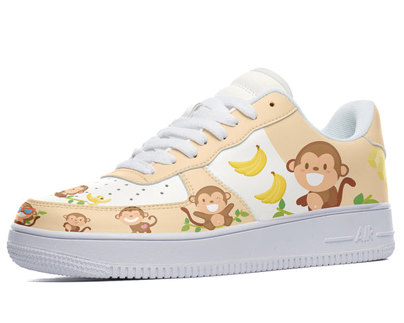 A white sneaker with a pattern of cartoon monkeys, bananas, and hearts.