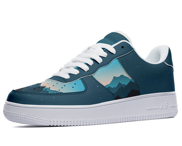 A dark blue sneaker with a white sole and white laces. The sneaker has a design of blue and purple mountains on the sides.