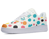 White low-top sneakers with a colorful polka dot design.