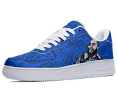 A blue sneaker with a white sole and white laces. The sneaker has a paisley pattern with a portrait of a man wearing a bandana over his mouth.