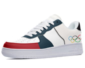 White, red, and blue sneakers with the Olympic rings printed on the side. 