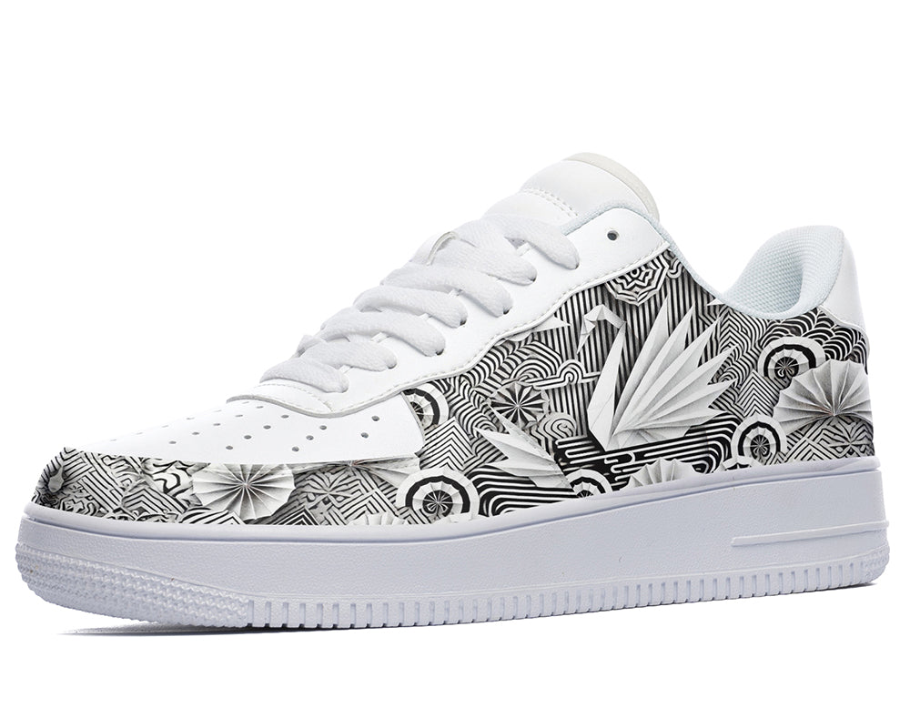 White court sneakers featuring black and white origami-inspired artwork with geometric paper-folding patterns and abstract monochrome design details.
