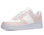 White low-top sneakers with a pink and white pearl design. 
