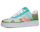 A close-up of a sneaker with a custom design. The sneaker is white with a blue swoosh and a light blue, pink, and green upper. The upper features a repeating pattern of cartoon wombats in various poses.