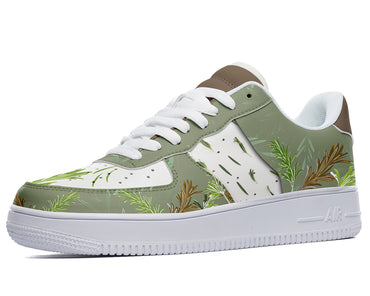 A close-up of a sneaker with a green, leafy pattern on the upper, white laces, a white midsole, and a white outsole.