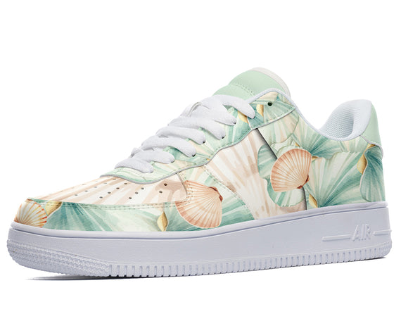 A close-up of a sneaker with a tropical floral pattern. The sneaker is white with light green, pink, and orange accents. The pattern features palm leaves, flowers, and shells.