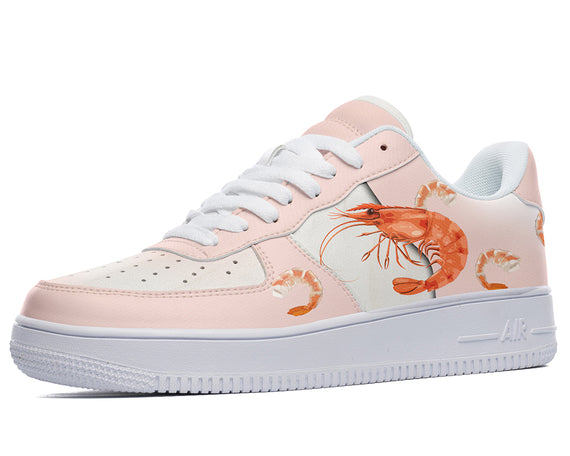 A pink sneaker with a white sole and white laces. The sneaker has a design of cooked shrimp on the side.