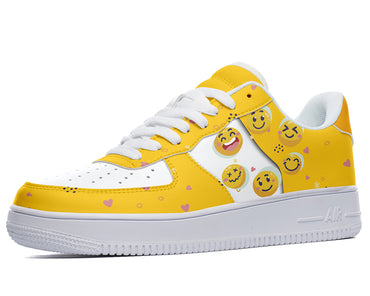 A yellow sneaker with a white sole, white laces, and a pattern of cartoon faces on the upper.