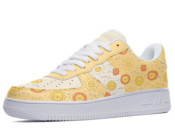 A yellow sneaker with a white sole, white laces, and a pattern of happy suns and clouds on the upper.