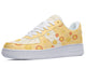 A yellow sneaker with a white sole, white laces, and a pattern of happy suns and clouds on the upper.