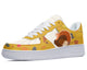 A white sneaker with a colorful pattern of a turkey, cornucopia, and fall leaves.