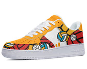 A mostly yellow sneaker with a white sole, white laces, and a colorful pattern of volleyballs, basketballs, and soccer balls on the sides.